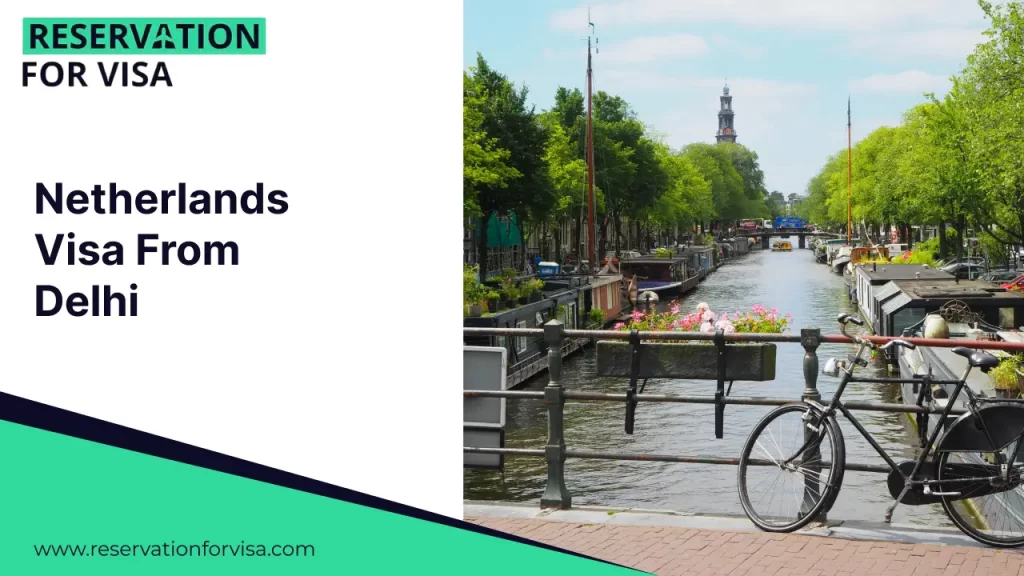 A promotional graphic for "Netherlands Visa From Delhi" by Reservation For Visa. The right side of the image shows a classic Amsterdam canal scene with houseboats moored along the water, lush green trees, and a black bicycle leaning against a bridge railing in the foreground.
